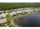 Aerial view of homes backing to a lake and lush tree line at 6109 Marsh Trail Dr, Odessa, FL 33556