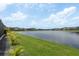 Scenic view of the backyard with lush grass and a serene lake at 6109 Marsh Trail Dr, Odessa, FL 33556