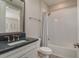 Well-lit bathroom featuring a modern vanity, a bathtub with a shower, and stylish finishes at 6109 Marsh Trail Dr, Odessa, FL 33556