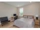 Cozy bedroom featuring a comfortable bed, a stylish desk, and a window with plenty of natural light at 6109 Marsh Trail Dr, Odessa, FL 33556