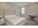 Light-filled bedroom with a plush bed, tufted headboard, and functional desk area at 6109 Marsh Trail Dr, Odessa, FL 33556