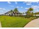 Clubhouse exterior showcasing manicured green lawn, palm trees, and a modern building design at 6109 Marsh Trail Dr, Odessa, FL 33556