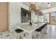 Chef's kitchen in a clubhouse that boasts bar seating and stylish pendant lighting at 6109 Marsh Trail Dr, Odessa, FL 33556