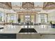 Modern clubhouse kitchen with stone counter tops, seating and relaxing views at 6109 Marsh Trail Dr, Odessa, FL 33556