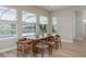 Dining area featuring natural light, a wooden table with seating for eight, and views of the pool at 6109 Marsh Trail Dr, Odessa, FL 33556