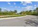 Entrance to the community showcasing well-maintained landscaping and a secure gate at 6109 Marsh Trail Dr, Odessa, FL 33556