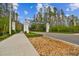 View of the community entrance featuring the Tarrarmore signage, landscaping, and a glimpse of the surrounding trees at 6109 Marsh Trail Dr, Odessa, FL 33556