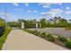 Community entrance gate with brick pillars, black metal accents, and neatly maintained greenery at 6109 Marsh Trail Dr, Odessa, FL 33556
