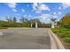 Community entrance gate with decorative pillars, black metal accents, and manicured landscaping at 6109 Marsh Trail Dr, Odessa, FL 33556