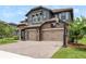 Two-story home with a three-car garage, stone accents, and a basketball hoop on the driveway at 6109 Marsh Trail Dr, Odessa, FL 33556