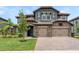 Two-story home with stone accents, a two-car garage, and a well-manicured lawn at 6109 Marsh Trail Dr, Odessa, FL 33556