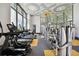 Bright gym featuring multiple machines, treadmills, ceiling fan, decorative ceiling and large window at 6109 Marsh Trail Dr, Odessa, FL 33556