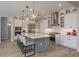 An open kitchen featuring stainless steel appliances, a large kitchen island, and modern lighting at 6109 Marsh Trail Dr, Odessa, FL 33556