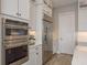 Updated kitchen with stainless steel refrigerator, wall oven, and white cabinets at 6109 Marsh Trail Dr, Odessa, FL 33556