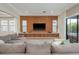 Spacious living room featuring a large sectional sofa, built-in media center, and sliding glass doors at 6109 Marsh Trail Dr, Odessa, FL 33556