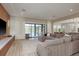 Open living room with view of the pool, lake and featuring a comfortable sectional couch at 6109 Marsh Trail Dr, Odessa, FL 33556