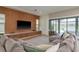 Living room showcasing a comfortable sectional sofa, a built-in entertainment center, and pool views at 6109 Marsh Trail Dr, Odessa, FL 33556