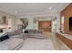 Open-concept living room with staircase, kitchen, and custom built-in cabinets at 6109 Marsh Trail Dr, Odessa, FL 33556