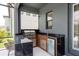 An outdoor kitchen featuring granite countertops, a stainless steel grill, and a mini fridge at 6109 Marsh Trail Dr, Odessa, FL 33556