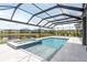 Enclosed pool area featuring a sparkling pool, a hot tub, a screened enclosure and a serene lake view at 6109 Marsh Trail Dr, Odessa, FL 33556