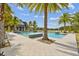 Beautiful community pool surrounded by palm trees and lounge chairs on a sunny day at 6109 Marsh Trail Dr, Odessa, FL 33556