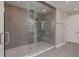 Modern bathroom featuring a glass-enclosed shower with dual shower heads and stylish gray tiling at 6109 Marsh Trail Dr, Odessa, FL 33556