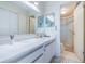 Bathroom with a white marble countertop, modern cabinets, and a glass-enclosed shower at 6145 Sun Blvd # 404, St Petersburg, FL 33715