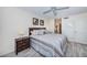 Cozy bedroom featuring a comfortable bed, a ceiling fan and a view of an ensuite bathroom at 6145 Sun Blvd # 404, St Petersburg, FL 33715