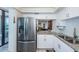 A modern kitchen with white cabinets, stainless steel appliances, granite countertops and a breakfast bar at 6145 Sun Blvd # 404, St Petersburg, FL 33715