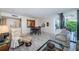 A spacious living room with light-colored floors, modern furnishings, and a glass-enclosed balcony at 6145 Sun Blvd # 404, St Petersburg, FL 33715