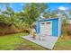 Backyard with a deck, a shed, Adirondack chairs, and well-maintained lawn and landscaping at 661 14Th S Ave, St Petersburg, FL 33701