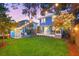 Beautiful backyard with a well-manicured lawn, string lights, and a screened porch for outdoor relaxation and entertaining at 661 14Th S Ave, St Petersburg, FL 33701