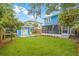 Backyard featuring green grass, shed, screened patio, and mature trees; great for outdoor enjoyment at 661 14Th S Ave, St Petersburg, FL 33701