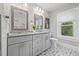 Bright bathroom with double vanity, neutral gray tones, and decorative tile flooring at 661 14Th S Ave, St Petersburg, FL 33701