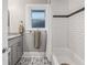 Bathroom featuring gray vanity, granite countertop, decorative floor tiles, and white subway tile in shower at 661 14Th S Ave, St Petersburg, FL 33701