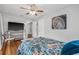 Bedroom featuring a ceiling fan, TV on a stand, and doorway leading to other rooms at 661 14Th S Ave, St Petersburg, FL 33701