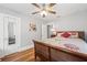 Bedroom with wood floors, ceiling fan and white doors; features a floral comforter and bright, natural light at 661 14Th S Ave, St Petersburg, FL 33701