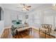 Bedroom with hardwood floors, ceiling fan, bench at the end of the bed, and a mirror at 661 14Th S Ave, St Petersburg, FL 33701