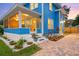 A charming blue two-story home boasts a well-manicured lawn and brick-paved driveway at 661 14Th S Ave, St Petersburg, FL 33701