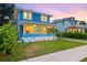 Charming blue home with a well-manicured lawn and a welcoming front porch at 661 14Th S Ave, St Petersburg, FL 33701