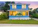 Charming blue two-story home with a cozy front porch and well-manicured lawn at dusk at 661 14Th S Ave, St Petersburg, FL 33701