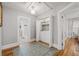 Hallway features in-unit laundry, access to bathroom with updated tile, and bedroom with wood floors at 661 14Th S Ave, St Petersburg, FL 33701