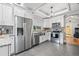 Bright white kitchen has granite counters, a farmhouse sink, and stainless steel appliances at 661 14Th S Ave, St Petersburg, FL 33701