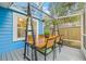 Covered patio with a wood dining table and seating; features outdoor lights and views of the yard at 661 14Th S Ave, St Petersburg, FL 33701