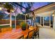 Screened-in porch with a large wooden table, pendant lights, and plants, perfect for dining or relaxing outdoors at 661 14Th S Ave, St Petersburg, FL 33701