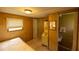 Cozy bedroom featuring a connecting bathroom and wood paneled walls at 7240 Ottley St, Zephyrhills, FL 33541
