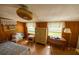 Bedroom with wood floors, wood paneling, and a fan at 7240 Ottley St, Zephyrhills, FL 33541