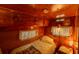 Cozy bedroom with wood paneling, built-in storage, and soft lighting at 7240 Ottley St, Zephyrhills, FL 33541
