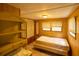 Bedroom features wood paneling, built-in shelving, and a closet at 7240 Ottley St, Zephyrhills, FL 33541