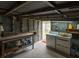 Rustic garage with a workbench, corrugated metal walls, and laundry area at 7240 Ottley St, Zephyrhills, FL 33541